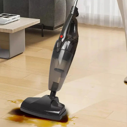 Black handheld vacuum cleaning the floor in a room with a sofa and table