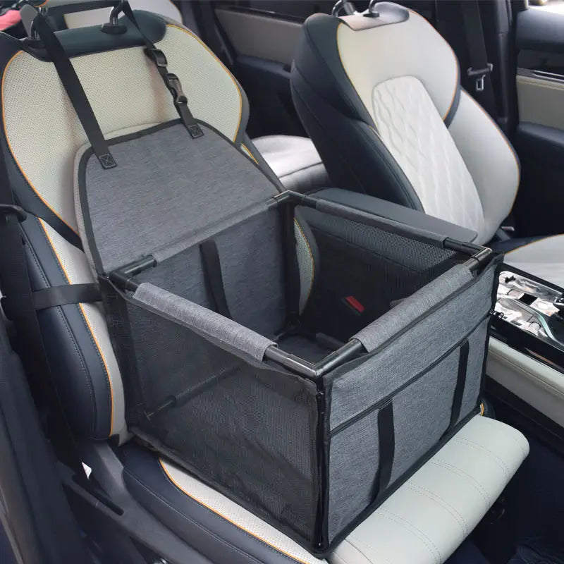 Dark grey SeatGuard foldable dog car booster seat installed on a car front seat