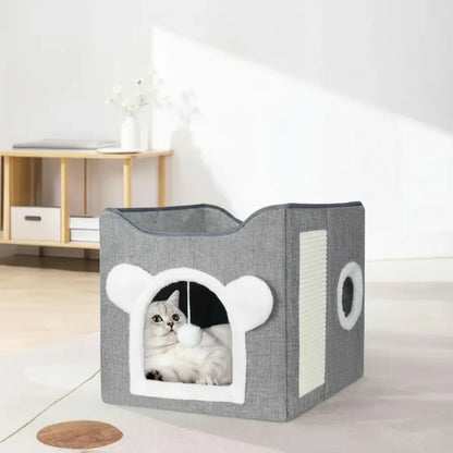 Gray pet house with a cat peeking out in a room setting