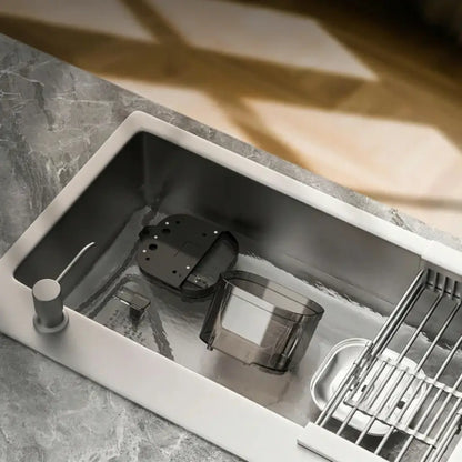 Modern kitchen sink with cat water fountain parts on a marble countertop