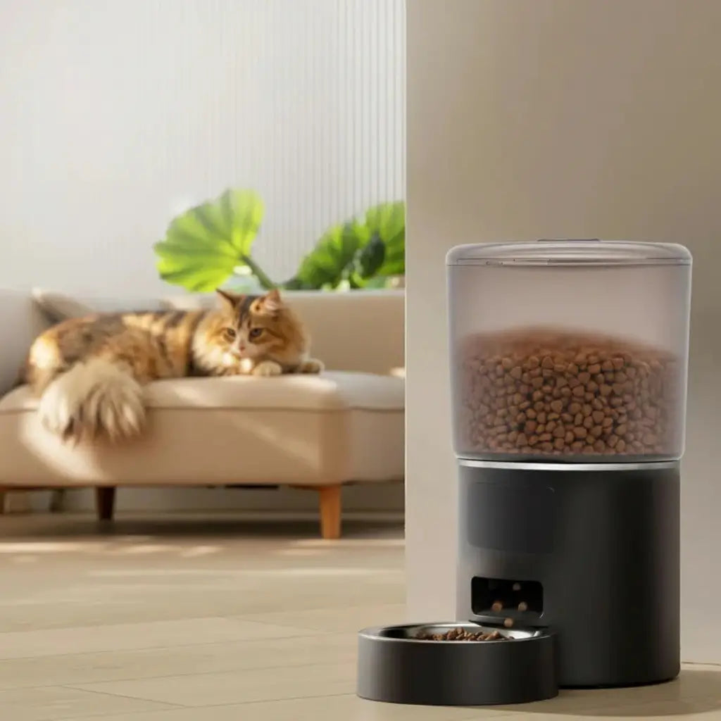 Pet food dispenser with a cat sitting on a couch in the background