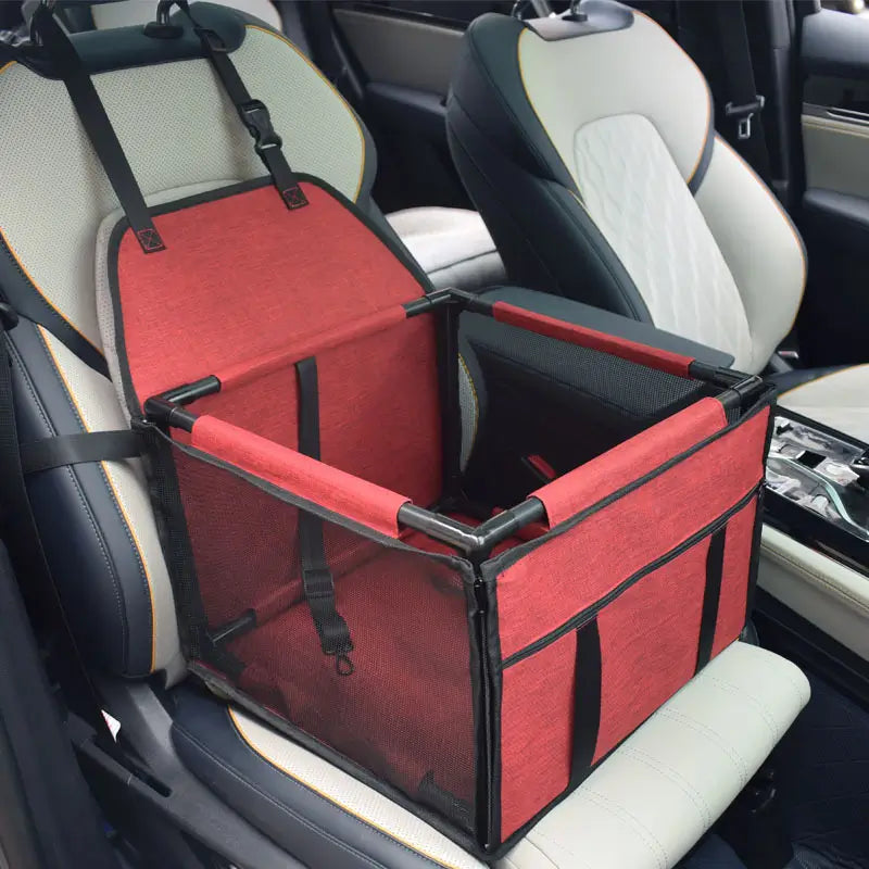 Red SeatGuard foldable dog car booster seat installed on a car front seat