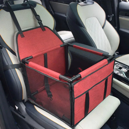 Red SeatGuard foldable dog car booster seat installed on a car front seat