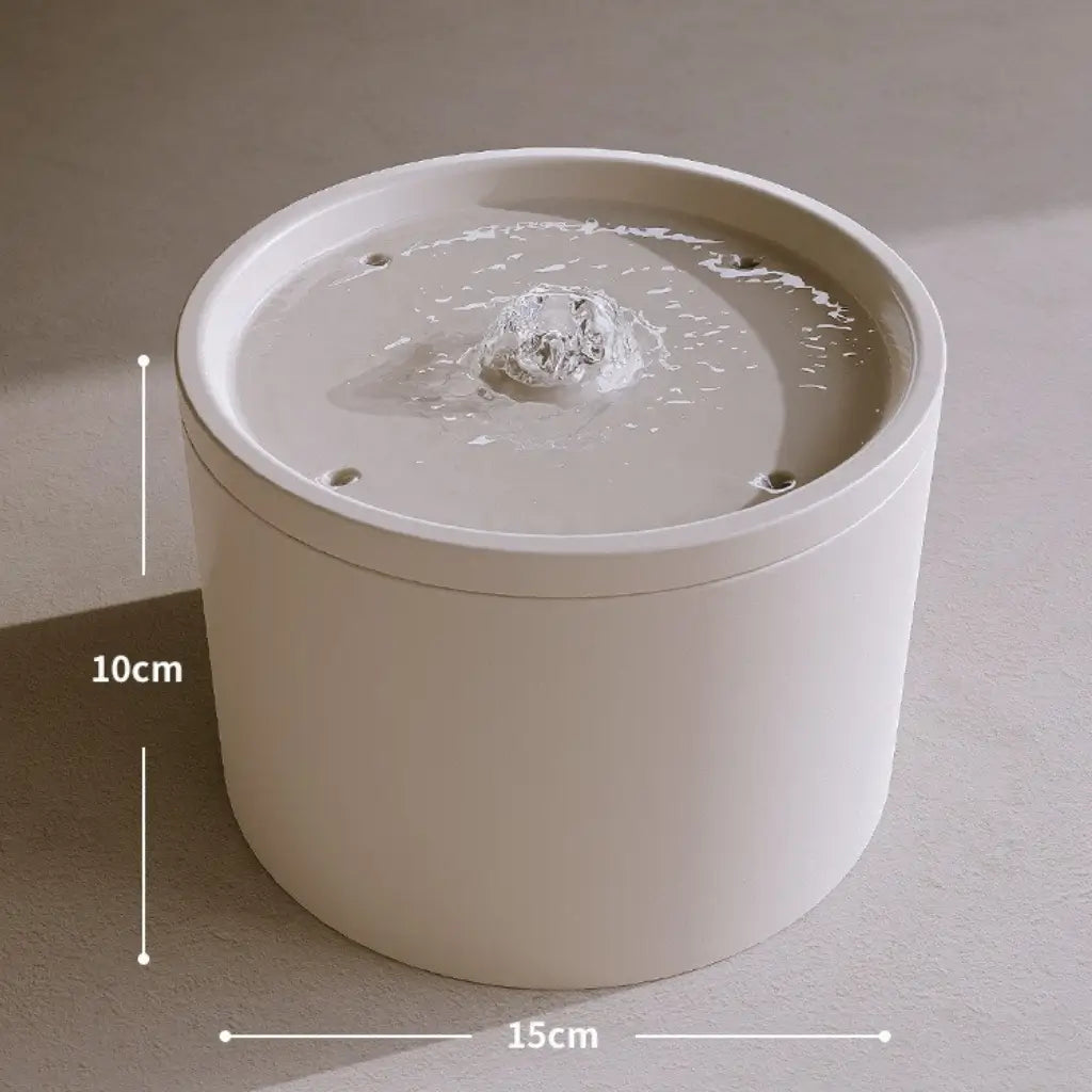 White ceramic water fountain with water inside, shown with measurements on a neutral background