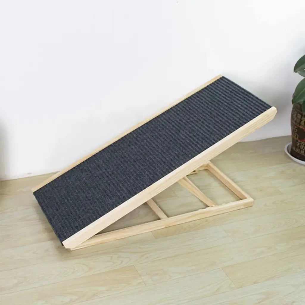 Wooden pet ramp with textured surface on a light wooden floor